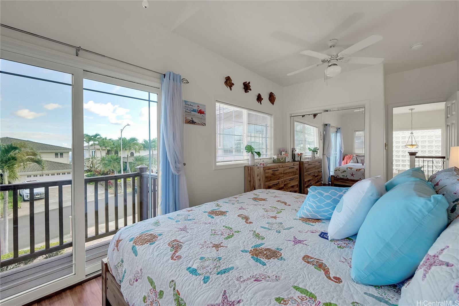 92-1306 Hauone Street Kapolei, HI 96707 - Photo 16 of 25 a large bedroom with a large bed and a window