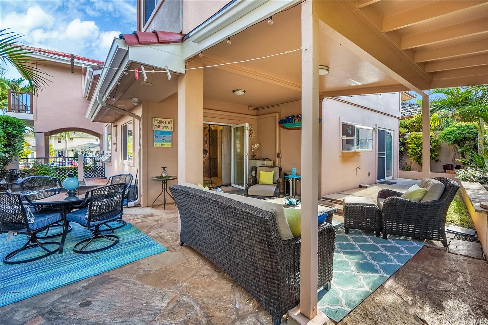 92-1306 Hauone Street Kapolei, HI 96707 - Photo 24 of 25 a view of a patio with couches table and chairs and potted plants