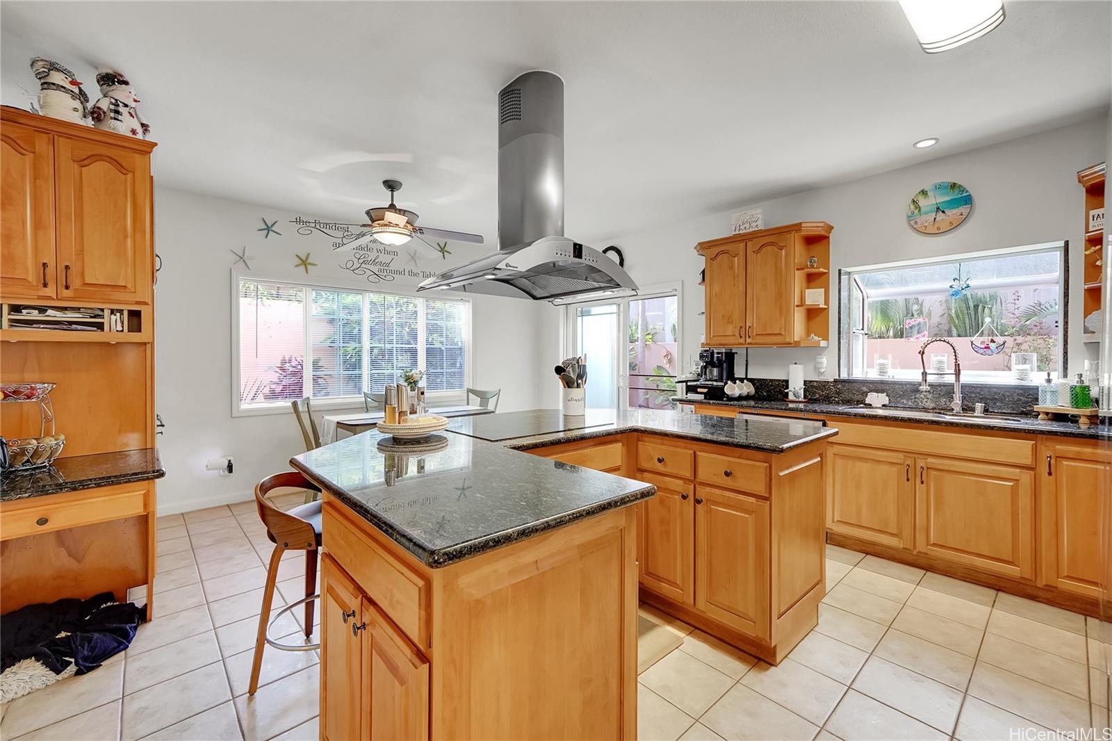 92-1306 Hauone Street Kapolei, HI 96707 - Photo 6 of 25 a kitchen with stainless steel appliances granite countertop a sink stove and refrigerator