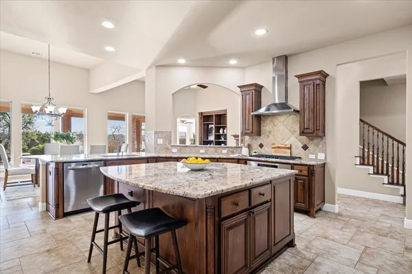 a kitchen with a stove a sink and a refrigerator