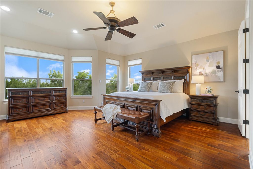 3920 Vail Divide Bee Cave, TX 78738 - Photo 13 of 34 a bedroom with a bed dresser and a floor to ceiling window