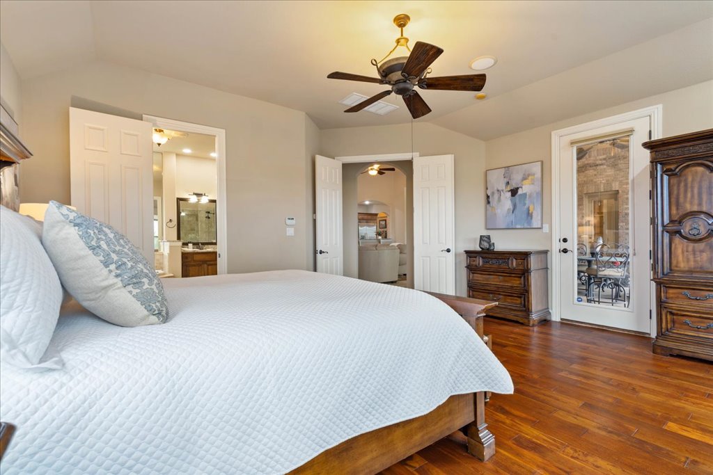 3920 Vail Divide Bee Cave, TX 78738 - Photo 14 of 34 a bedroom with a bed and a chandelier