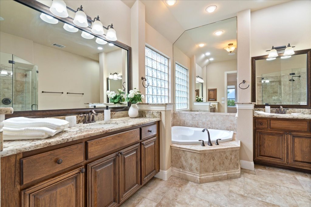 3920 Vail Divide Bee Cave, TX 78738 - Photo 15 of 34 a spacious bathroom with a granite countertop sink mirror and bathtub