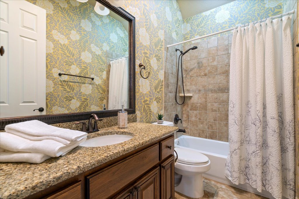 3920 Vail Divide Bee Cave, TX 78738 - Photo 22 of 34 a bathroom with a granite countertop sink toilet and shower