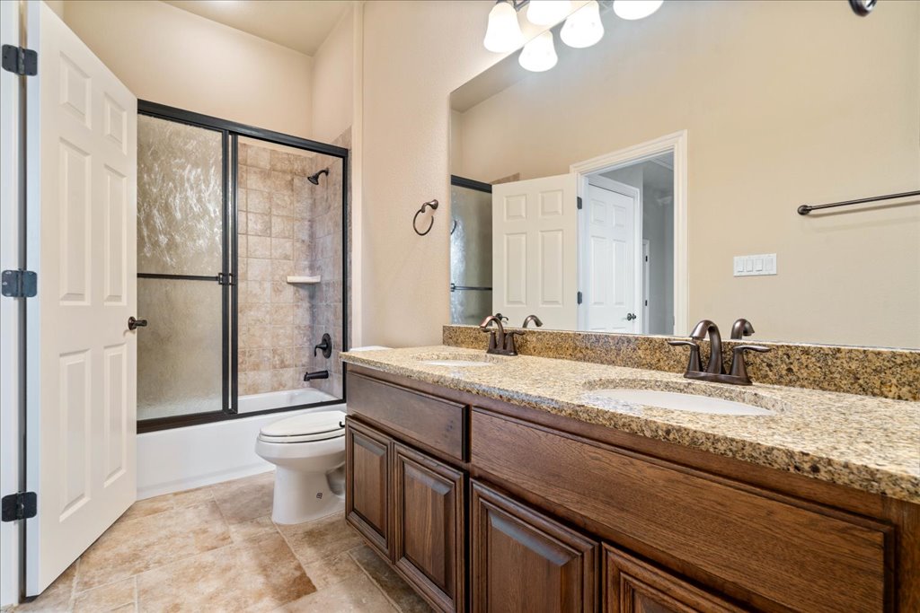 3920 Vail Divide Bee Cave, TX 78738 - Photo 25 of 34 a bathroom with a granite countertop sink mirror vanity and toilet