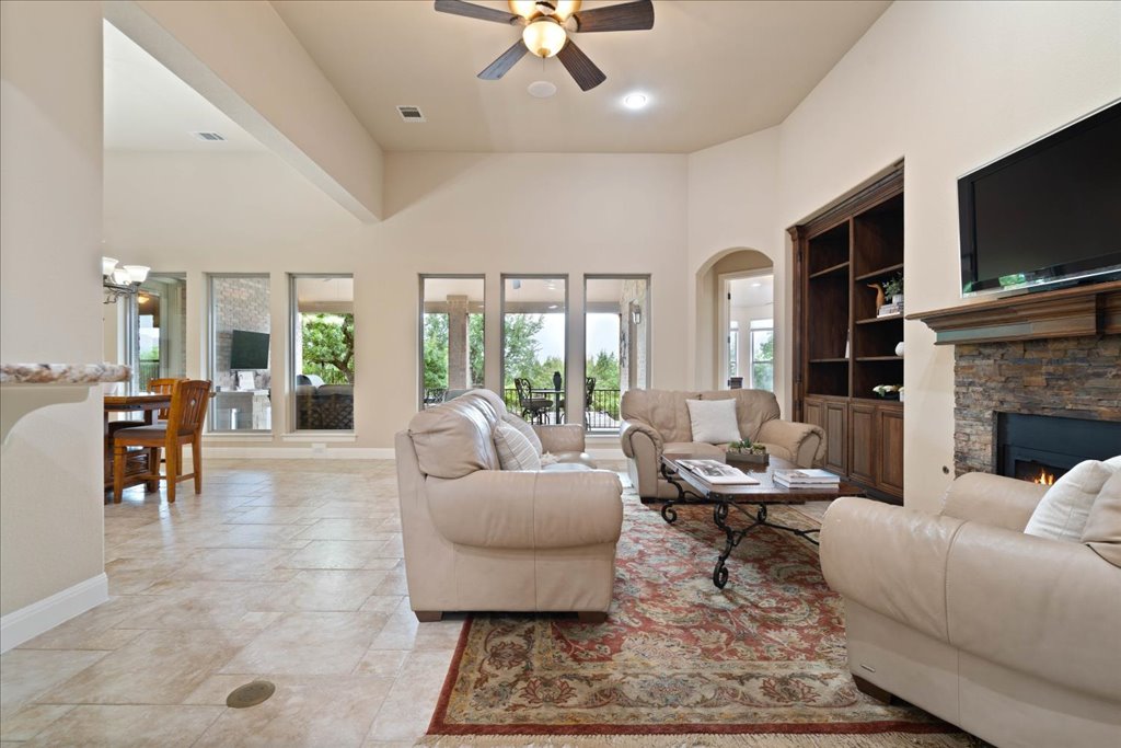 3920 Vail Divide Bee Cave, TX 78738 - Photo 6 of 34 a living room with fireplace furniture and a flat screen tv
