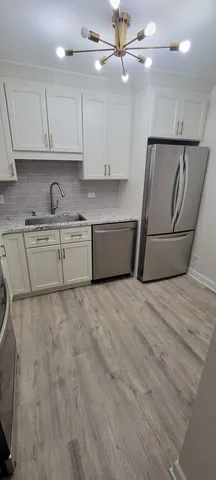 a kitchen with granite countertop a sink a stove and cabinets