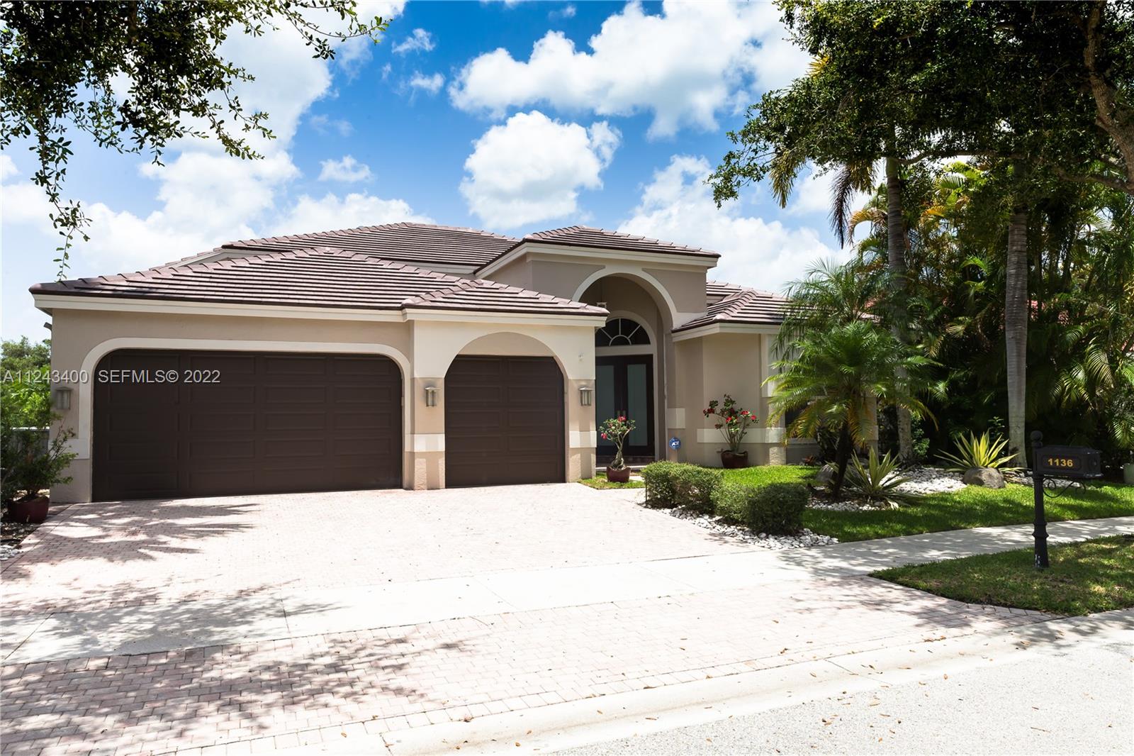 1136 Ginger Circle Weston, FL 33326 - Photo 1 of 32 a front view of a house with a yard