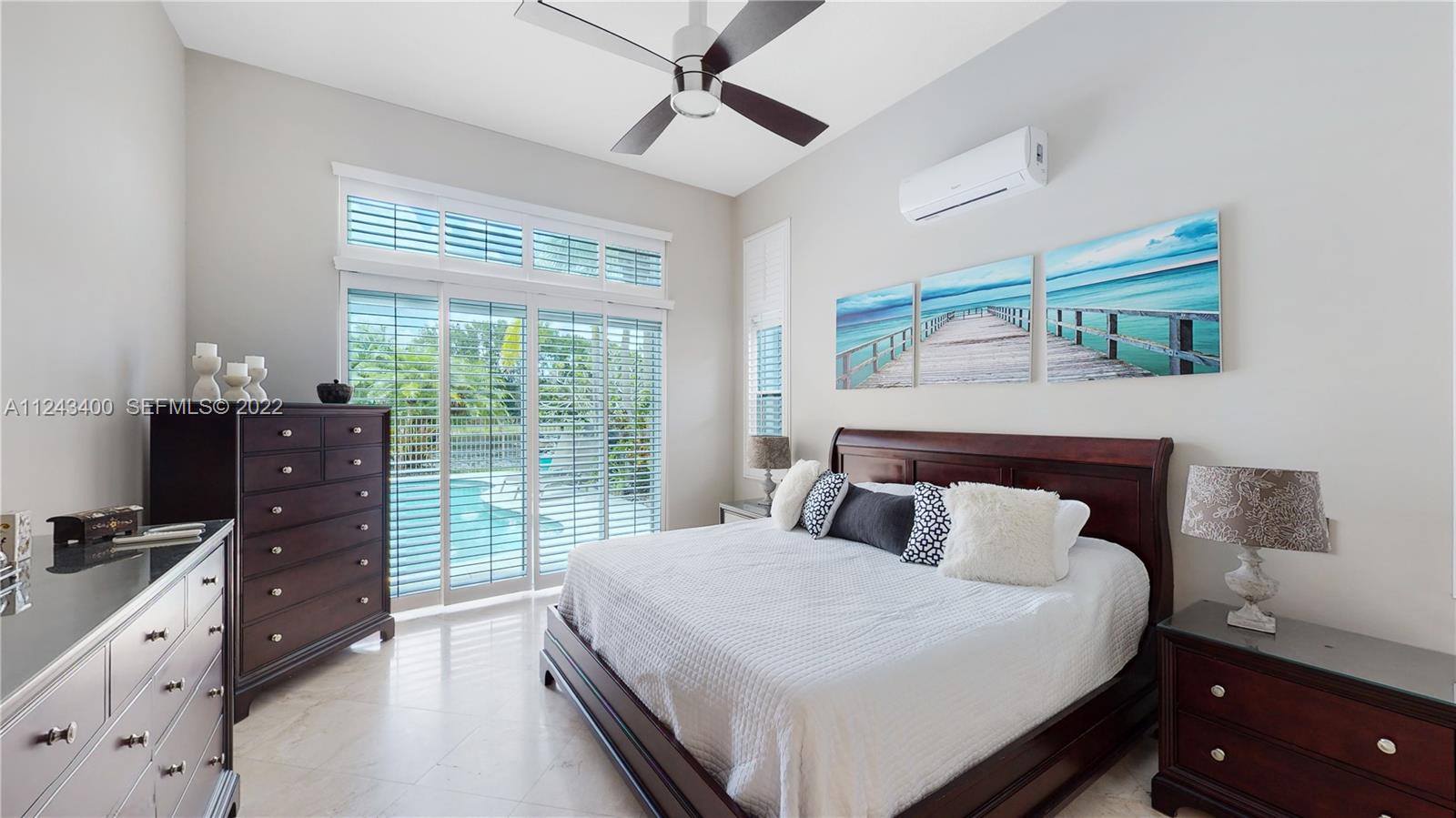 1136 Ginger Circle Weston, FL 33326 - Photo 11 of 32 a bedroom with a bed and a window