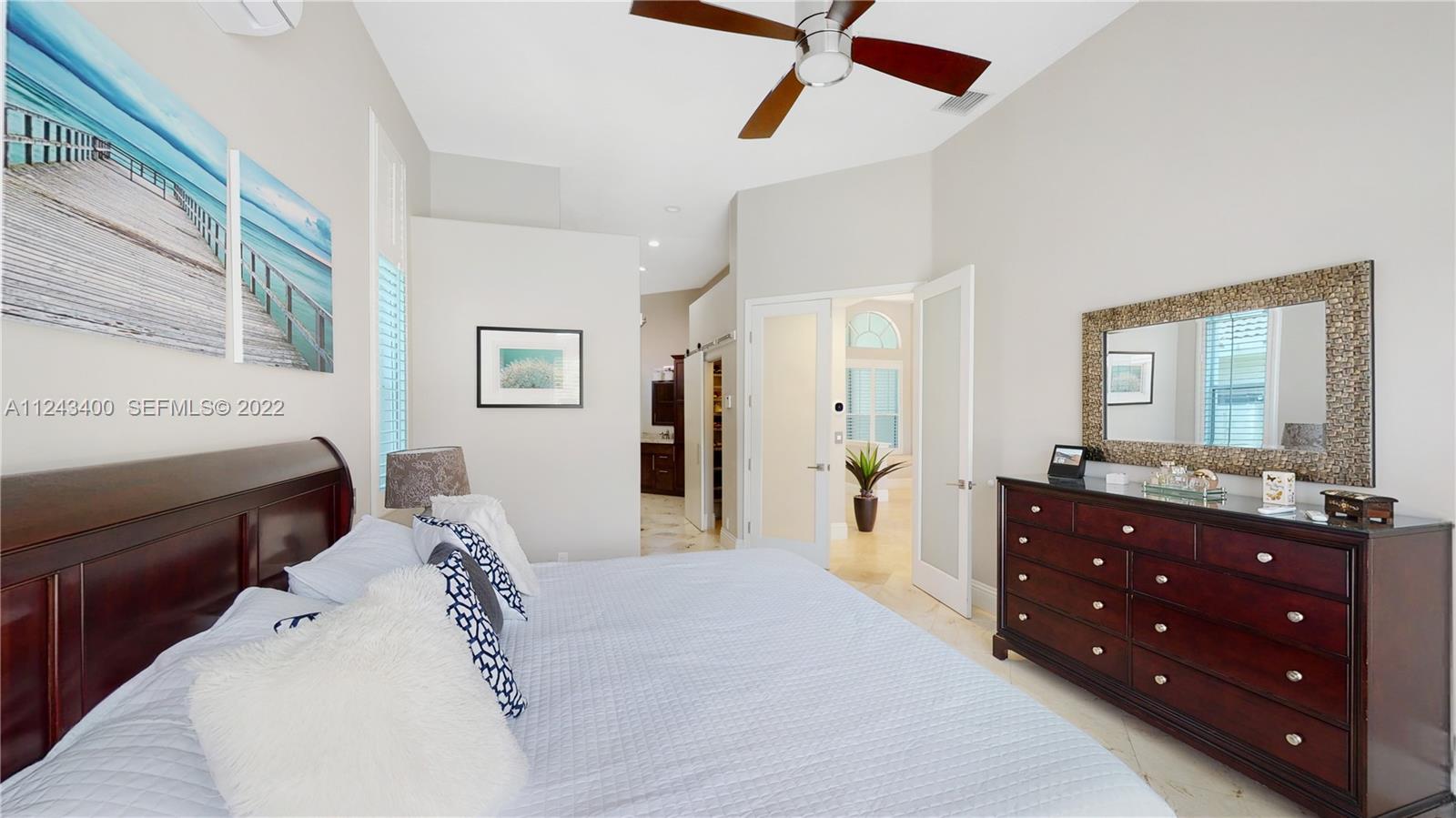 1136 Ginger Circle Weston, FL 33326 - Photo 12 of 32 a spacious bedroom with a bed and a dresser