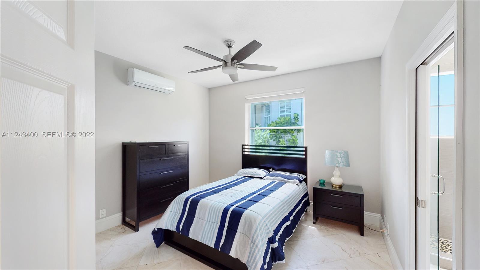 1136 Ginger Circle Weston, FL 33326 - Photo 13 of 32 a bedroom with a bed and a window