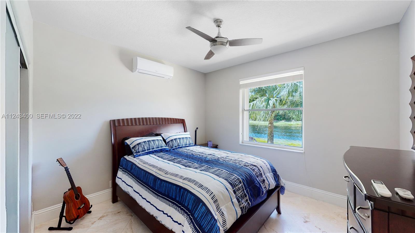 1136 Ginger Circle Weston, FL 33326 - Photo 15 of 32 a bedroom with a bed a window and chair