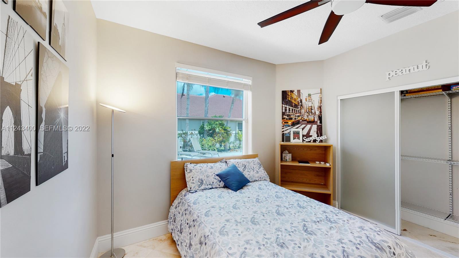 1136 Ginger Circle Weston, FL 33326 - Photo 16 of 32 a bedroom with a bed and a dresser next to a window