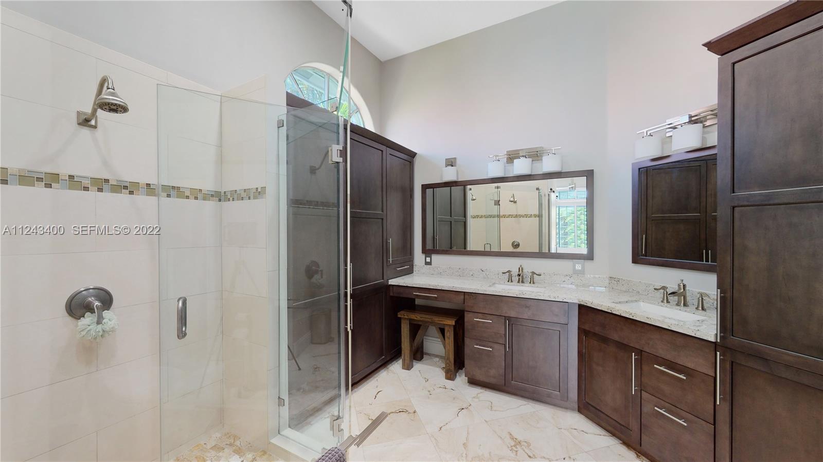 1136 Ginger Circle Weston, FL 33326 - Photo 18 of 32 a spacious bathroom with a granite countertop sink a mirror and shower