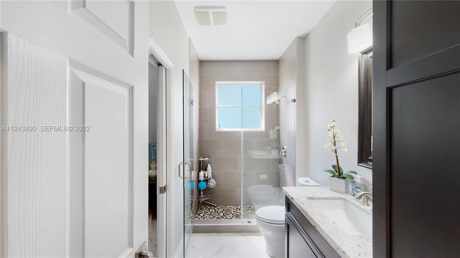 1136 Ginger Circle Weston, FL 33326 - Photo 19 of 32 a bathroom with a granite countertop sink a toilet and shower