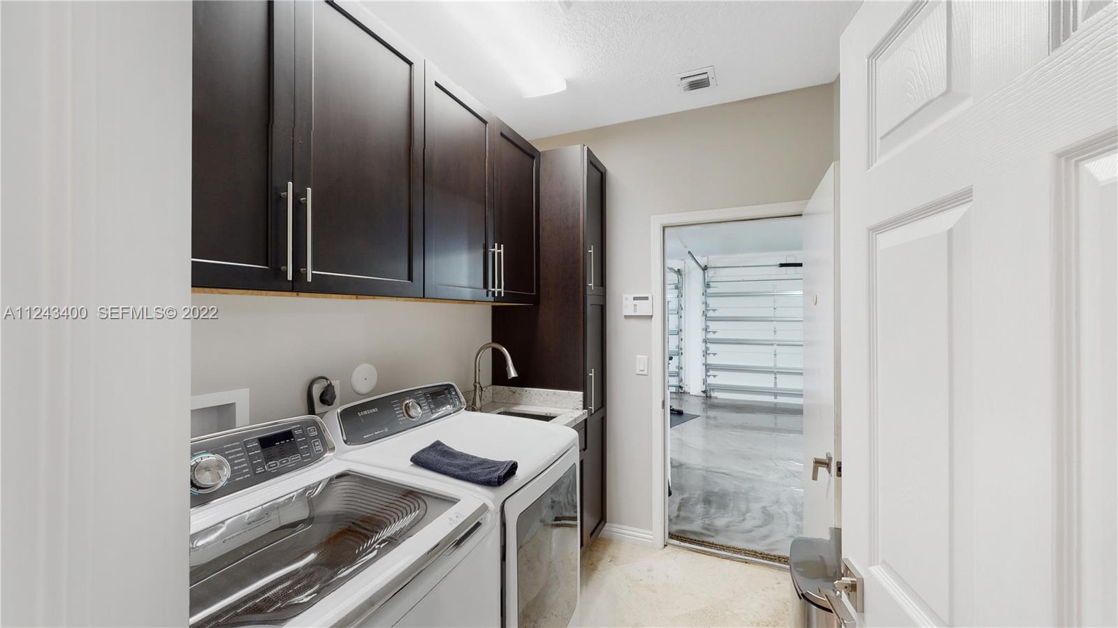 1136 Ginger Circle Weston, FL 33326 - Photo 21 of 32 a kitchen that has a sink and a stove