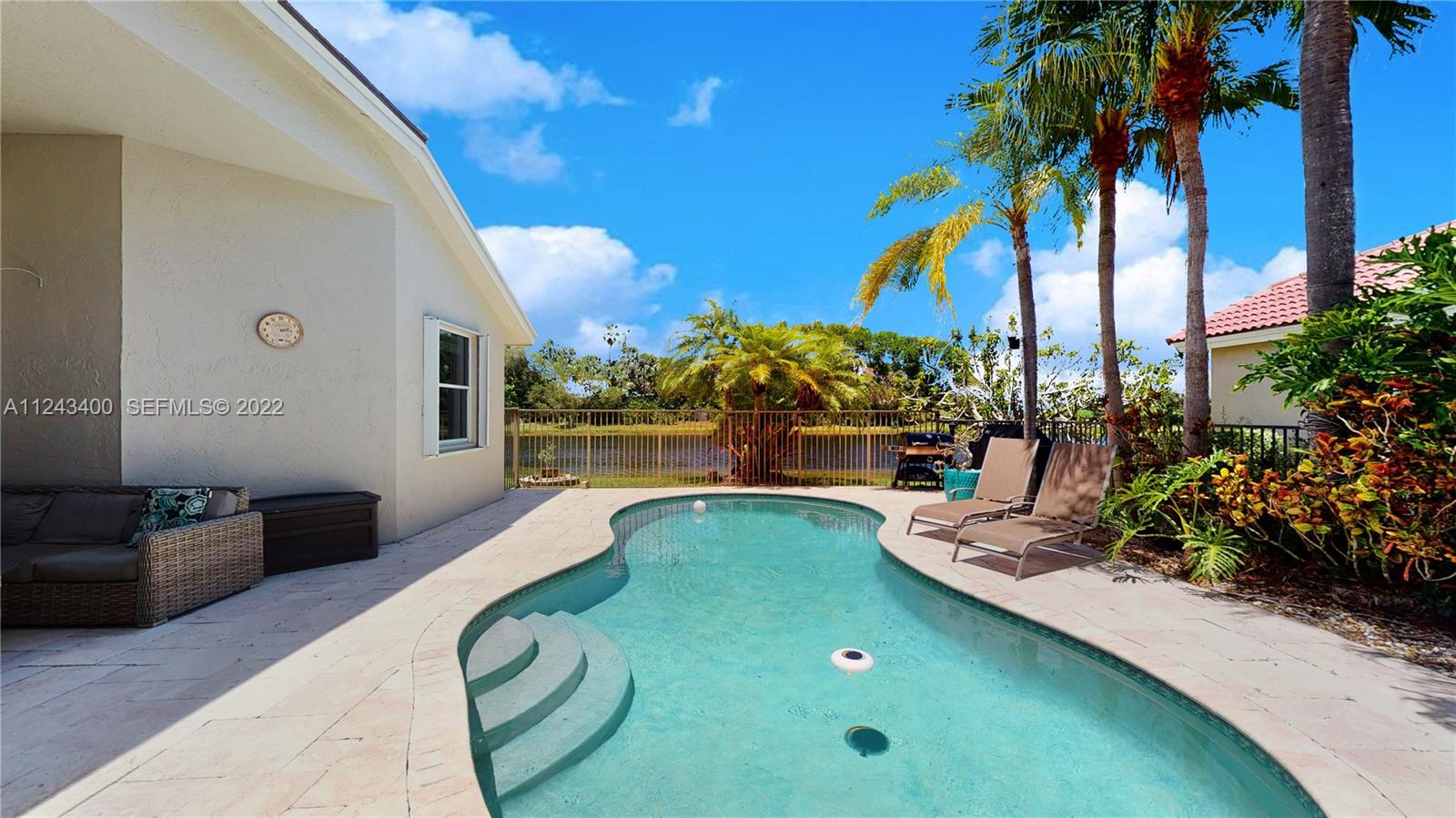 1136 Ginger Circle Weston, FL 33326 - Photo 24 of 32 a view of a backyard with plants and swimming pool