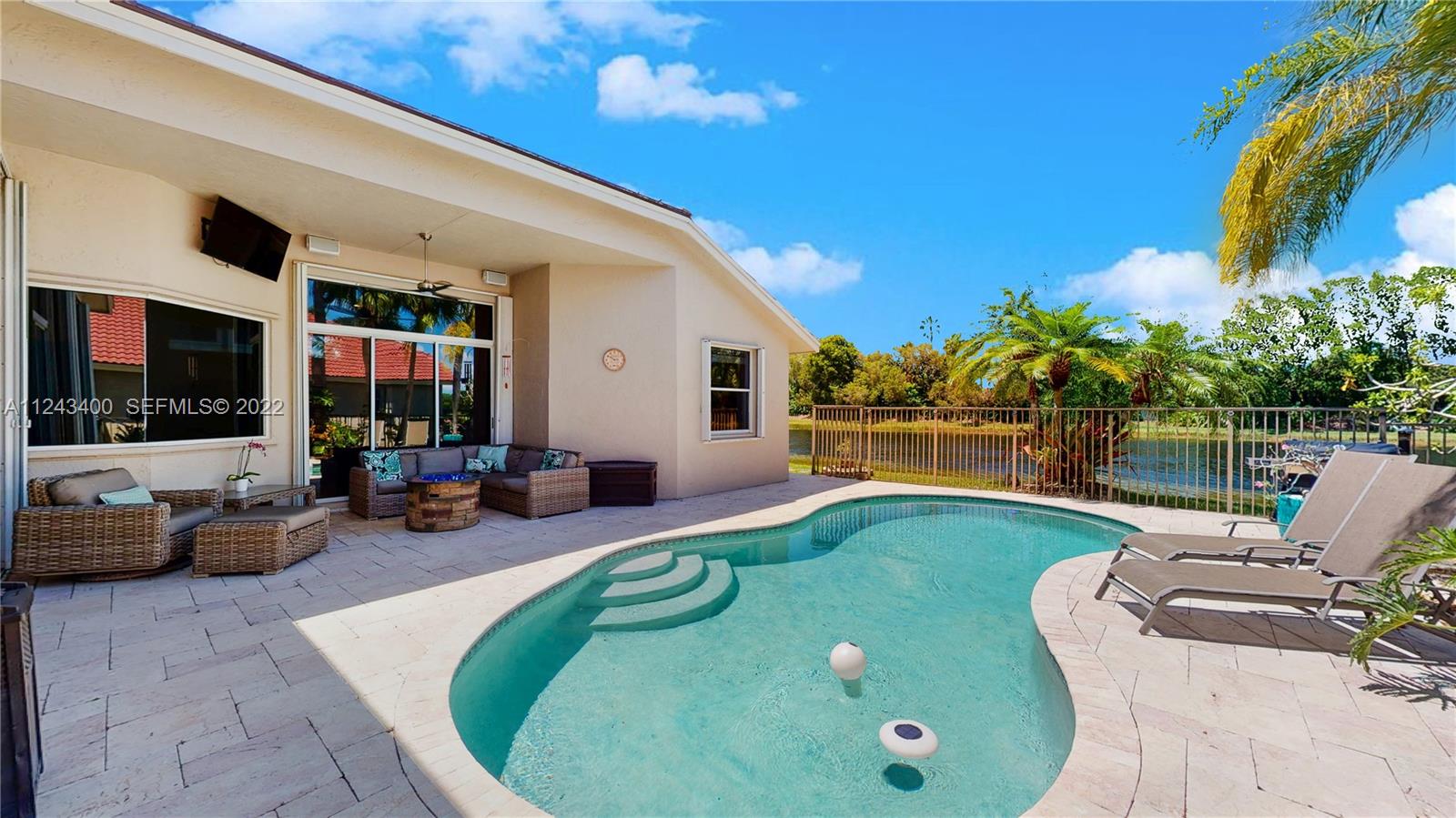 1136 Ginger Circle Weston, FL 33326 - Photo 25 of 32 a view of a swimming pool with furniture