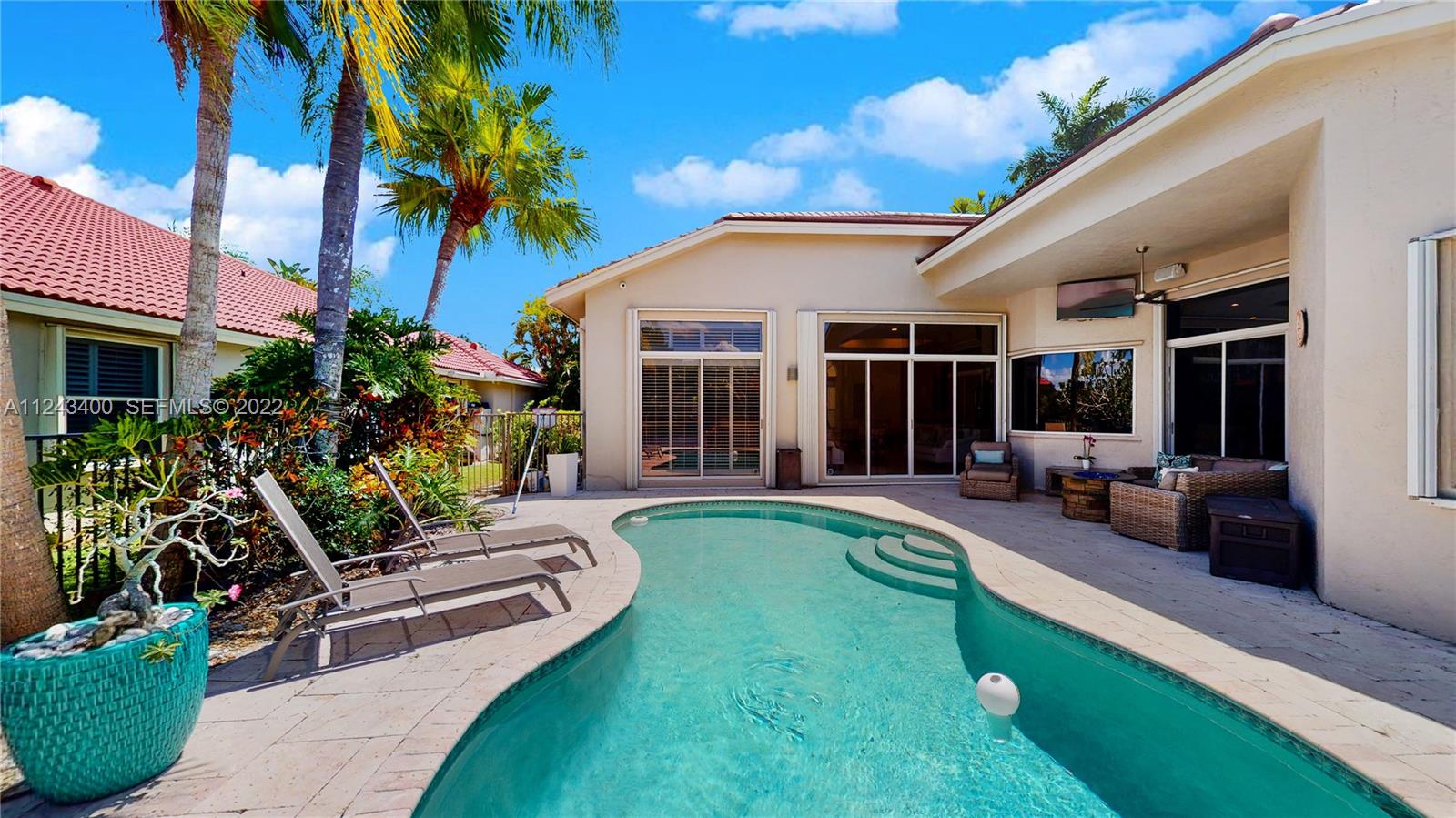 1136 Ginger Circle Weston, FL 33326 - Photo 26 of 32 a view of a house with backyard swimming pool and sitting area