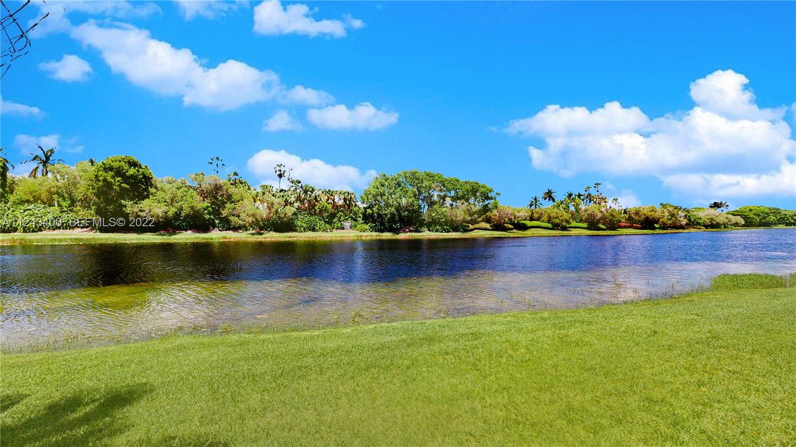 1136 Ginger Circle Weston, FL 33326 - Photo 27 of 32 a view of a lake with houses in the back