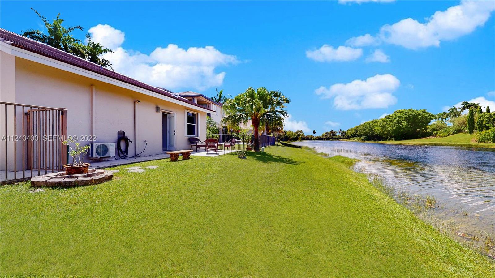 1136 Ginger Circle Weston, FL 33326 - Photo 28 of 32 a view of a swimming pool with a yard and plants