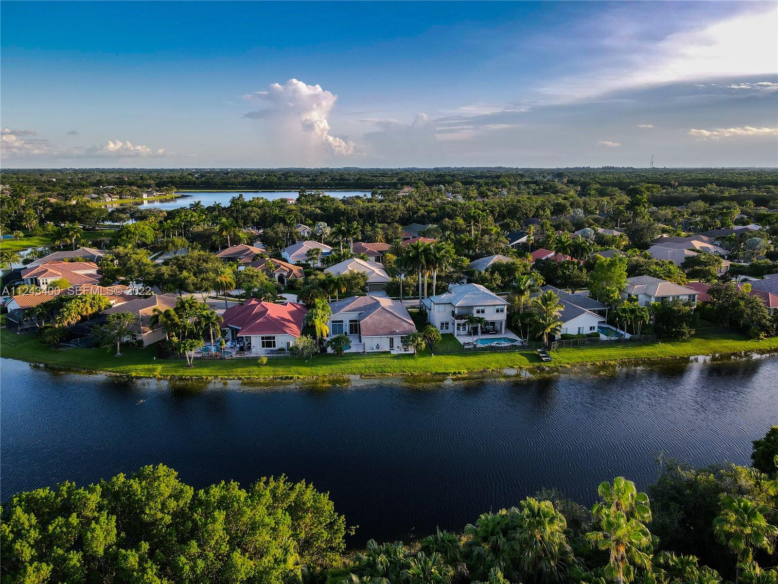 1136 Ginger Circle Weston, FL 33326 - Photo 4 of 32 an aerial view of a houses with a lake