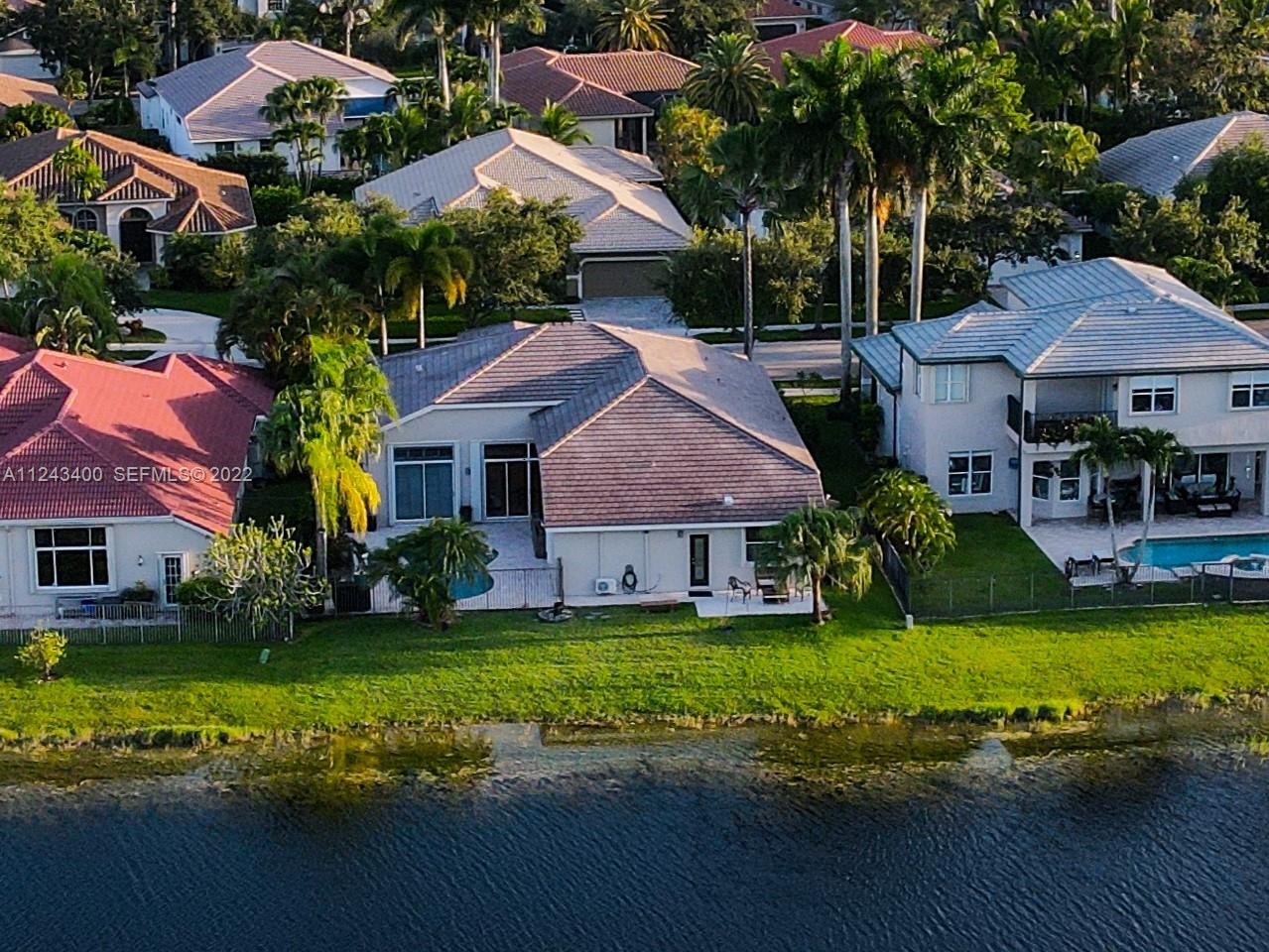1136 Ginger Circle Weston, FL 33326 - Photo 5 of 32 a view of a house with swimming pool and a yard