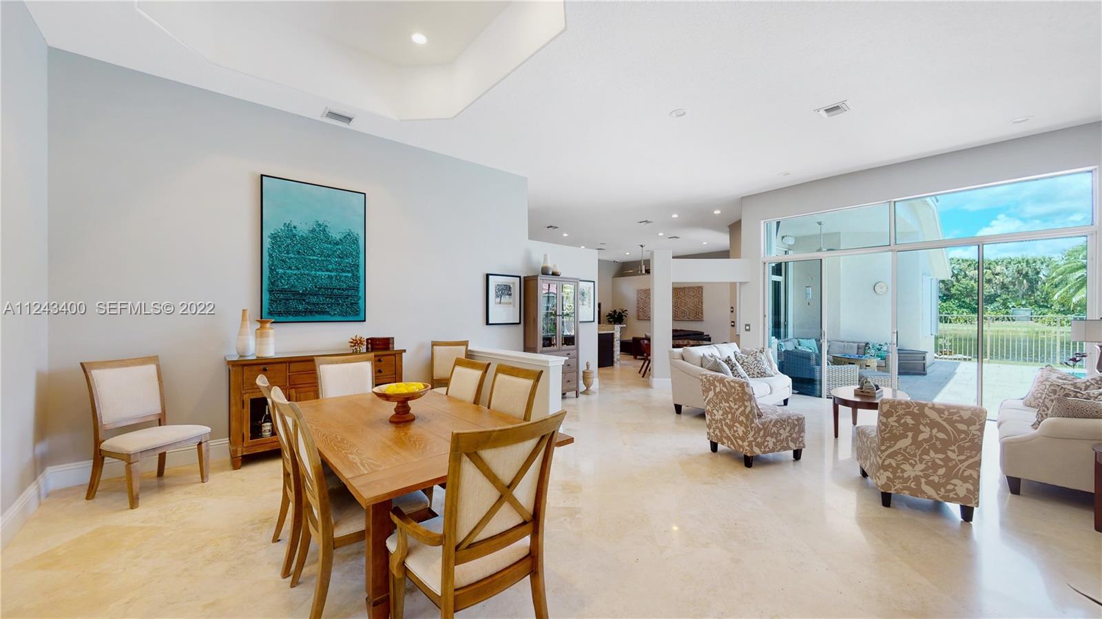1136 Ginger Circle Weston, FL 33326 - Photo 8 of 32 a dining room with furniture and large windows