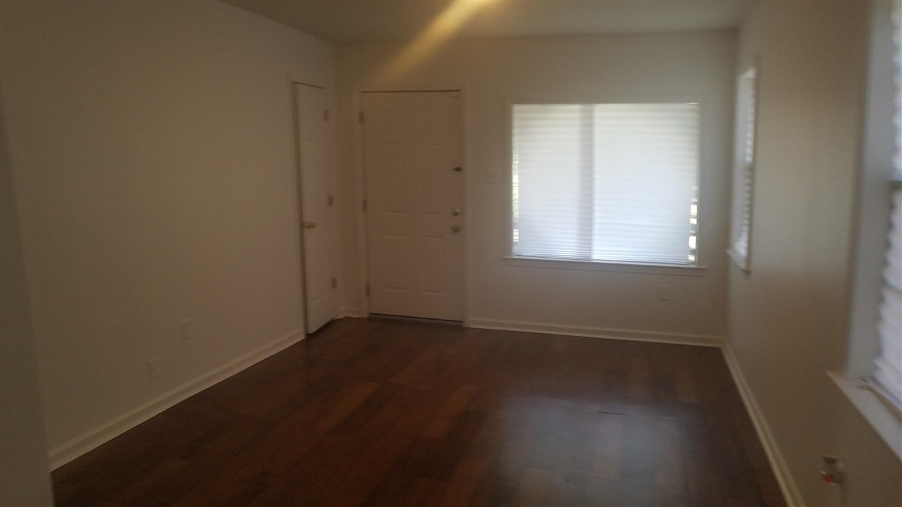 365 King Road Memphis, TN 38109 - Photo 4 of 9 an empty room with wooden floor and windows