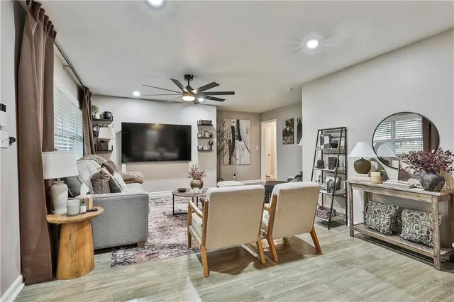 a living room with fireplace furniture and a flat screen tv