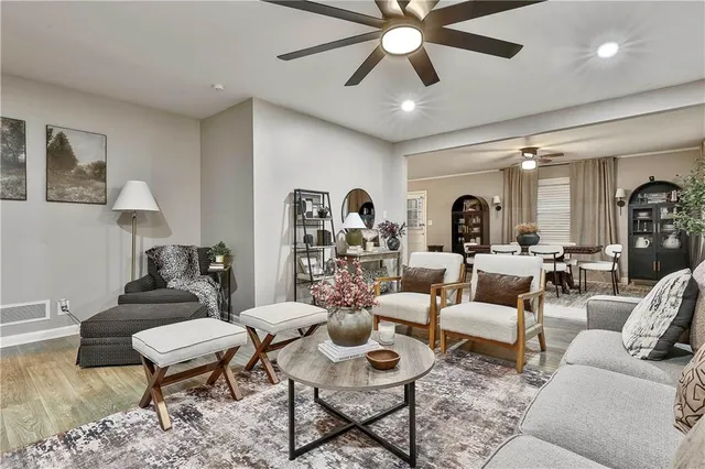 a living room with furniture and a chandelier