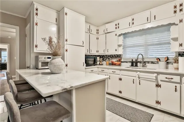 a kitchen with a sink cabinets and wooden floor