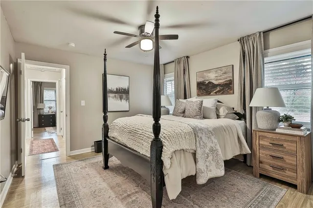 a spacious bedroom with a bed and a chandelier