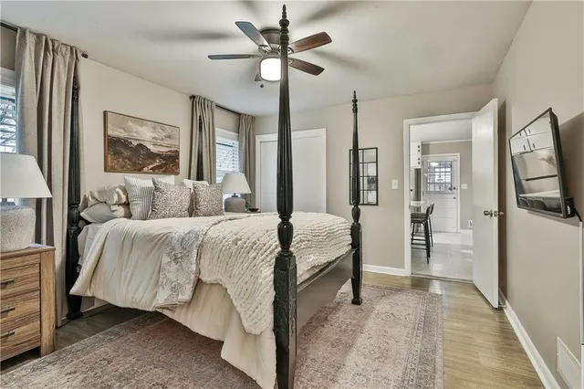 a bedroom with a bed and a painting on the wall