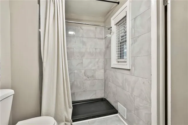 a bathroom with a glass door shower
