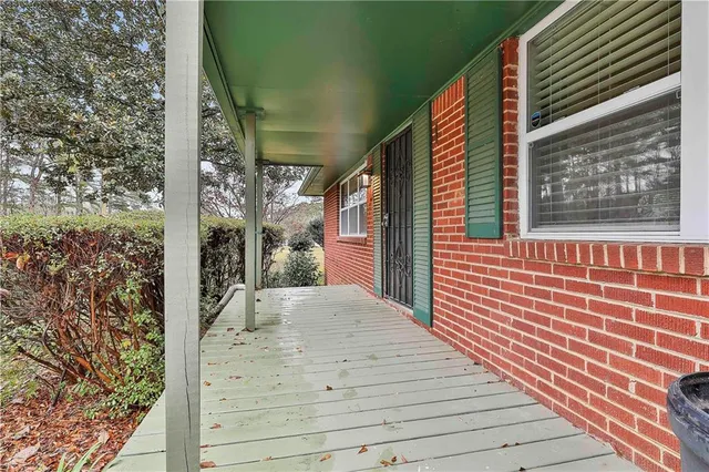 a view of a house with a door and wooden floor