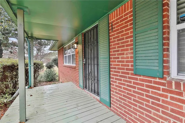 a view of a balcony with wooden floor and fence