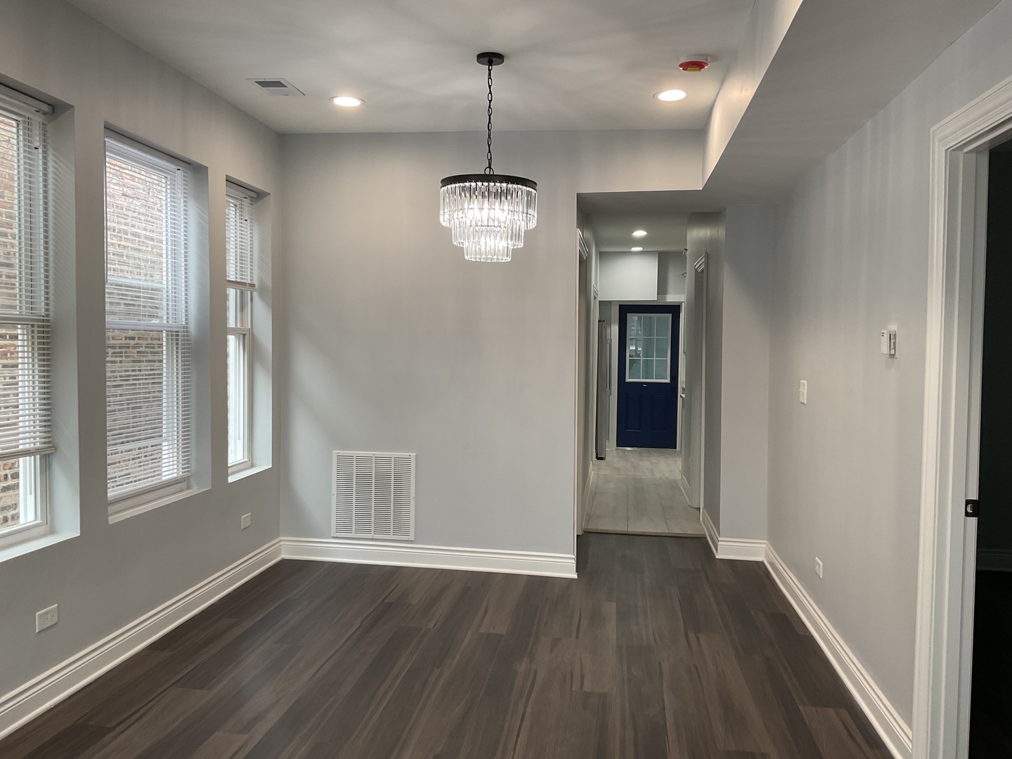 7940 South Carpenter Street, Unit 2 Chicago, IL 60620 - Photo 5 of 34 an empty room with wooden floor and windows