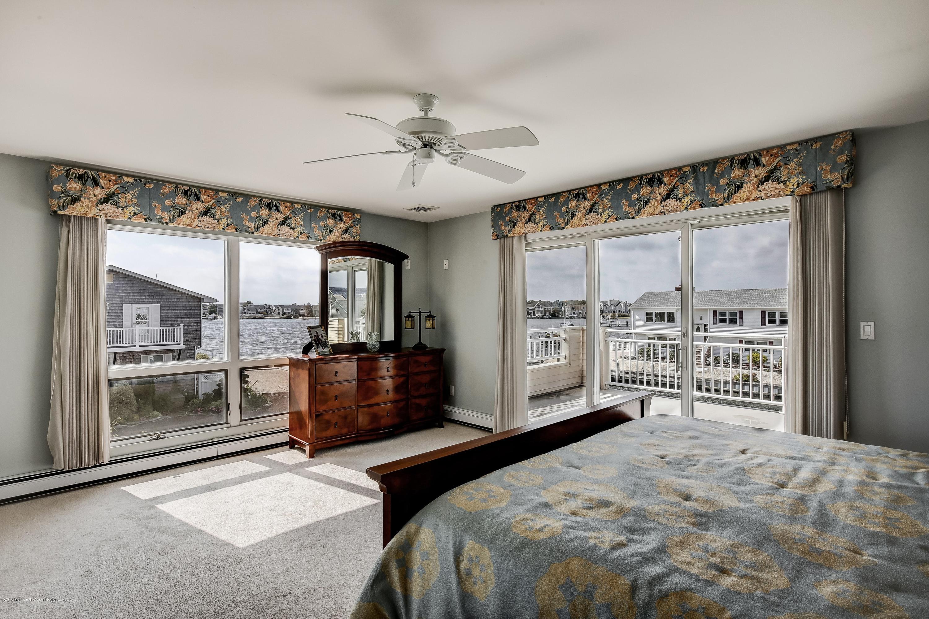 6 Neptune Road Toms River, NJ 08753 - Photo 22 of 38 a bedroom with a large bed and a large window