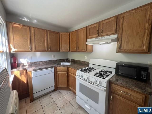 a kitchen with granite countertop cabinets stainless steel appliances and a wooden floor