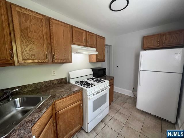 44 Gates Avenue, Unit 2 Montclair, NJ 07042 - Photo 3 of 15 a kitchen with a stove cabinets and a refrigerator