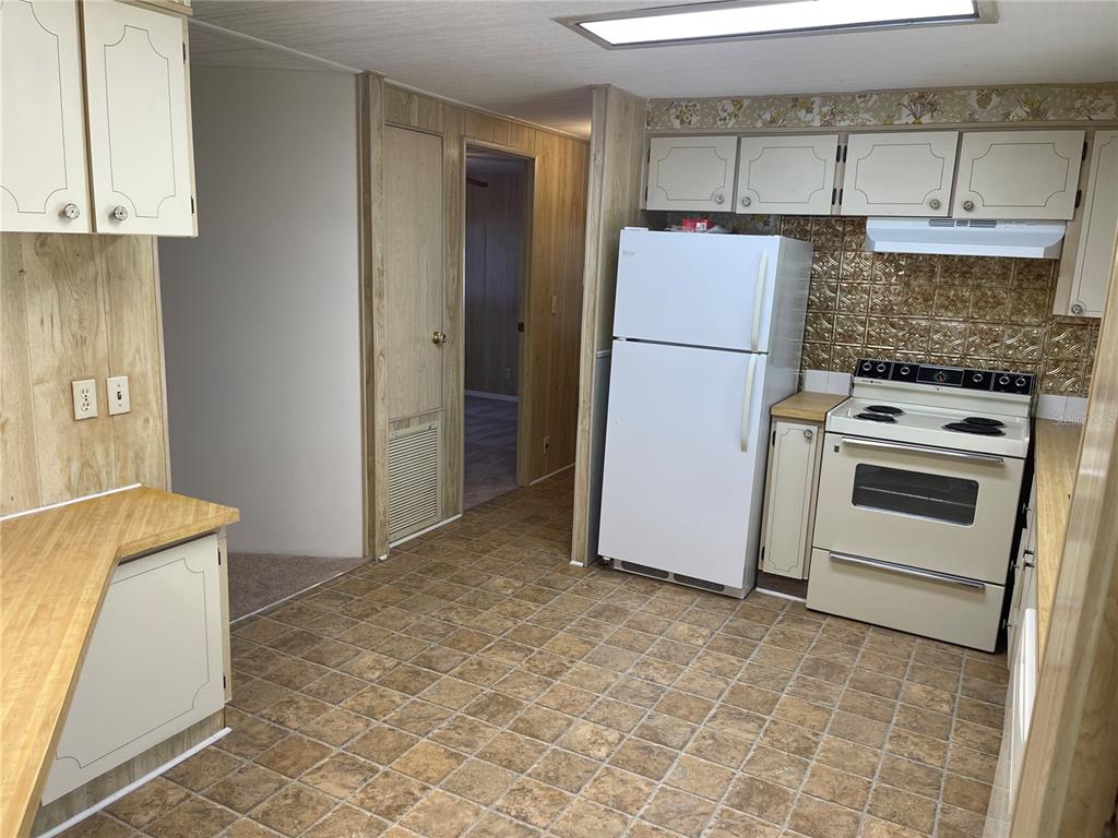109 Ridge Manor Drive Lake Wales, FL 33853 - Photo 9 of 16 a kitchen with a refrigerator and a stove