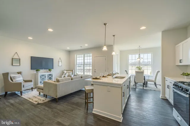 a room with a lot of white furniture appliances and a window