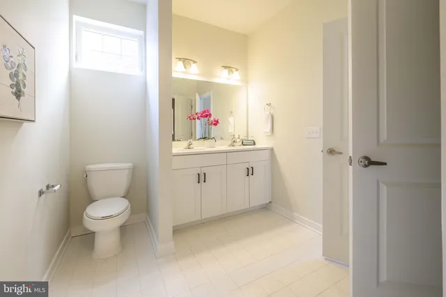 a bathroom with a sink toilet and a mirror