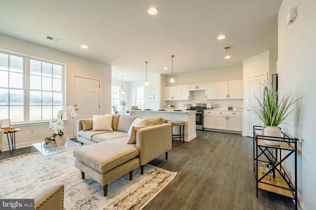a living room with furniture a dining table and a large window