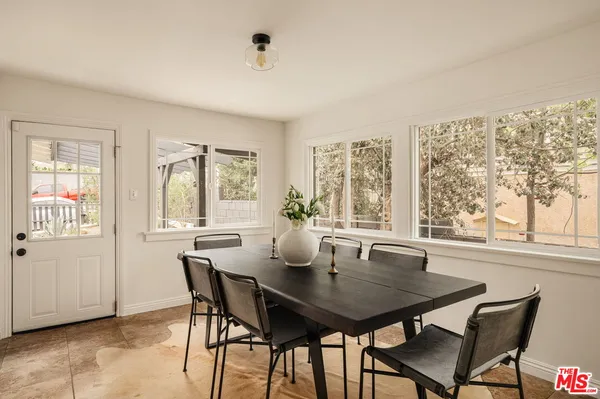 a view of a dining room with furniture and window