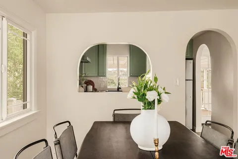 a view of a dining room with furniture and window
