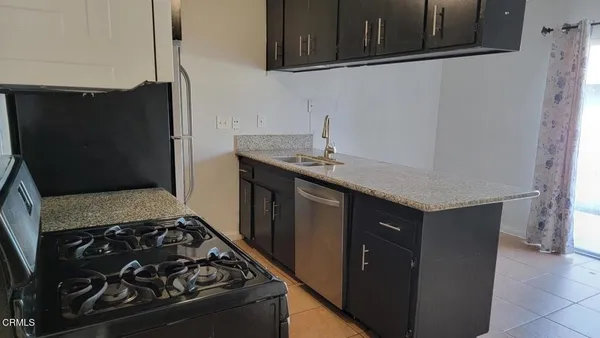 a kitchen with a stove and a refrigerator