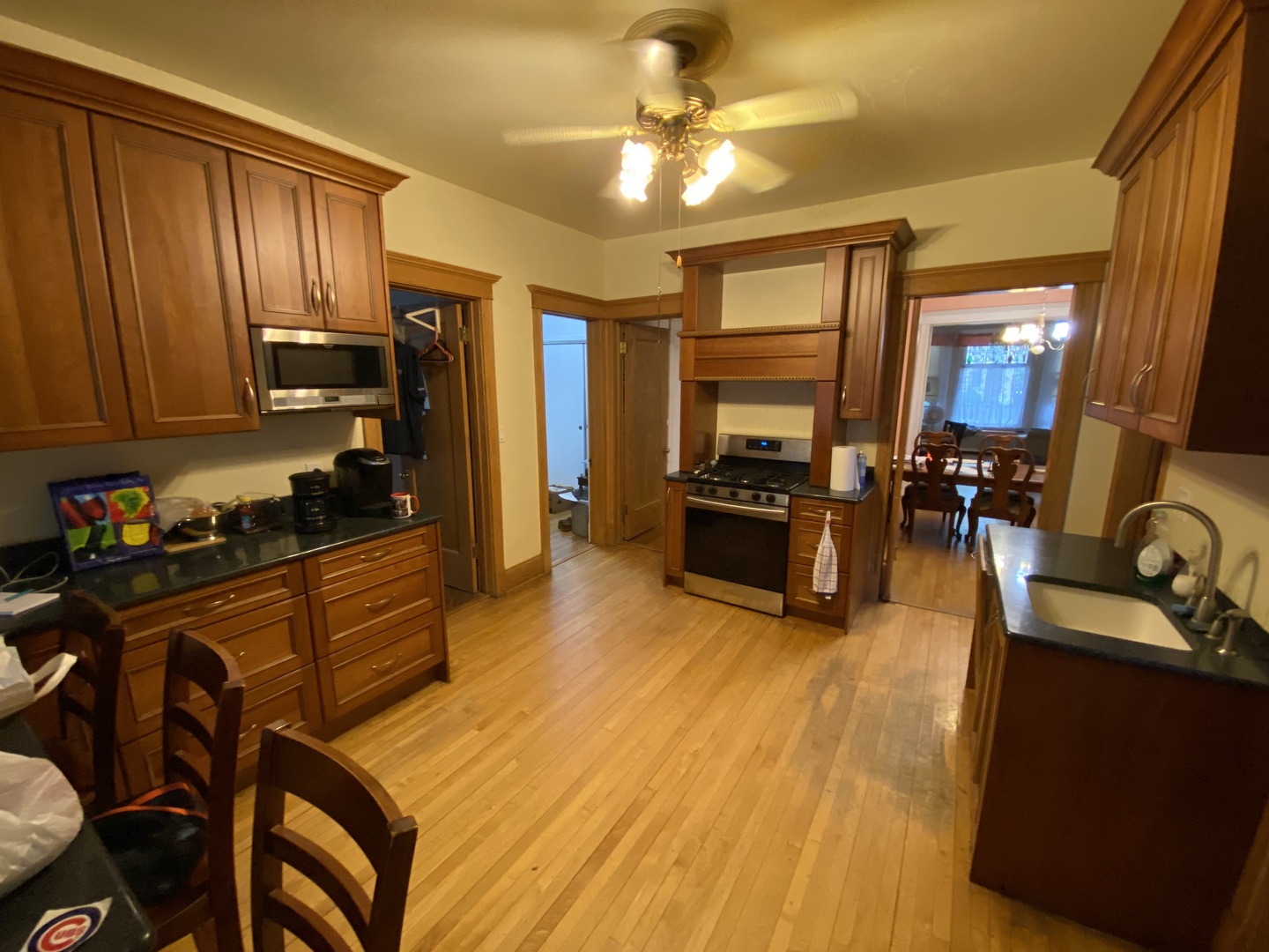 3902 North Hamilton Avenue Chicago, IL 60618 - Photo 12 of 24 a kitchen with stainless steel appliances wooden floors stove top oven and sink