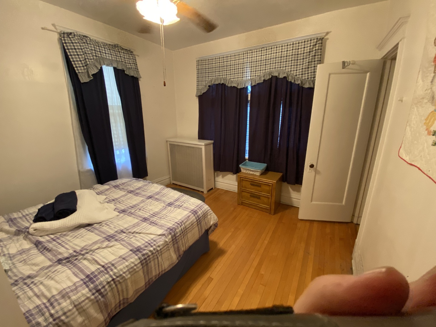 3902 North Hamilton Avenue Chicago, IL 60618 - Photo 17 of 24 a bedroom with a bed a mirror and a chandelier